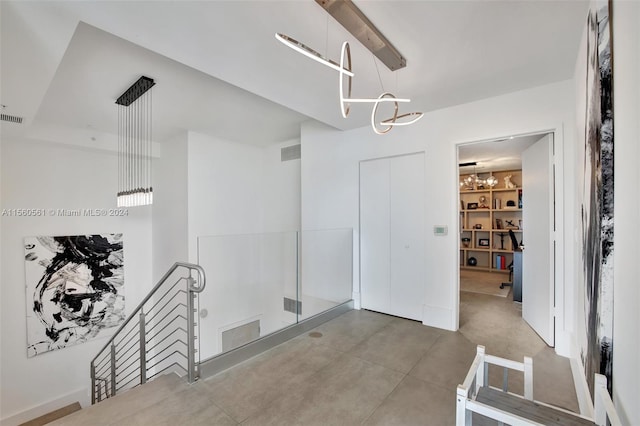 interior space with a notable chandelier and tile floors