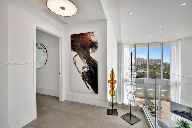 interior space featuring floor to ceiling windows and light tile flooring