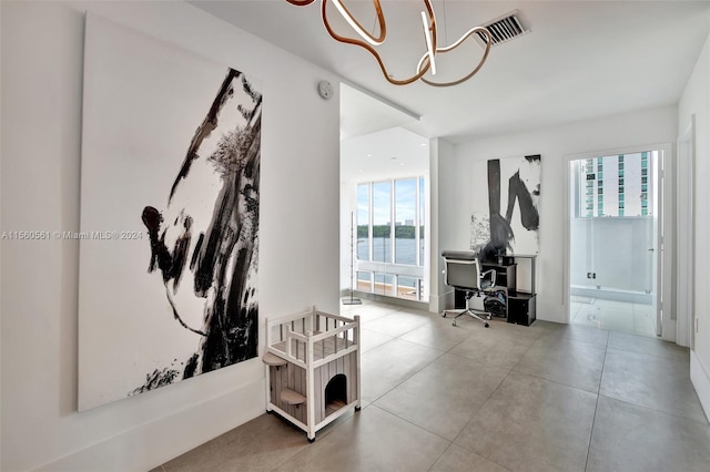 interior space featuring a notable chandelier and a water view