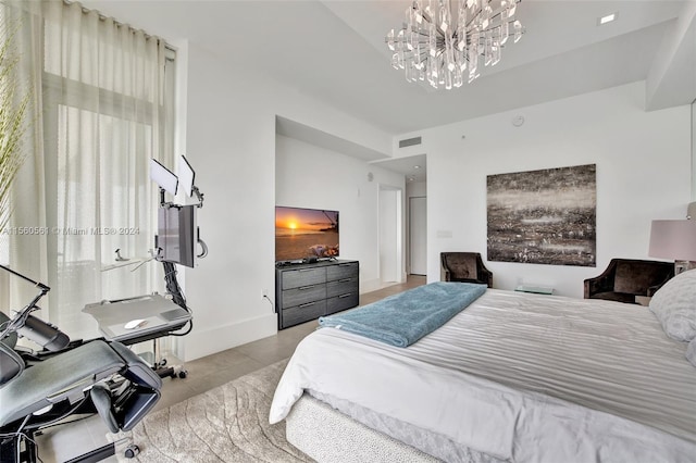 bedroom with tile floors and a notable chandelier