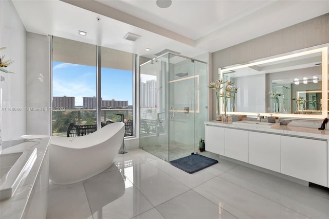 bathroom with separate shower and tub, vanity, and tile floors