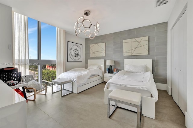 bedroom featuring a closet and tile walls