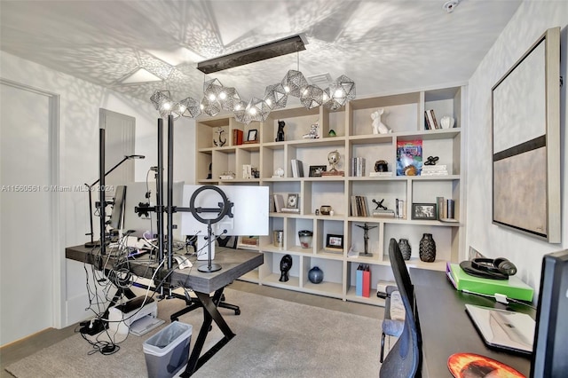 workout area with an inviting chandelier