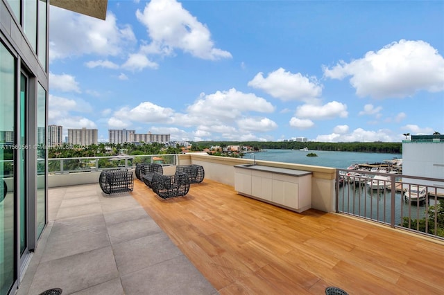 view of terrace featuring a balcony and a water view