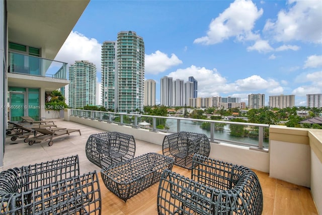 view of patio / terrace featuring a water view and a balcony