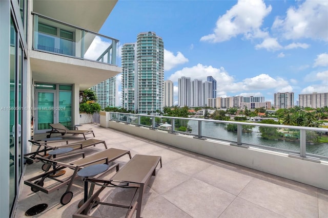 view of patio / terrace featuring a balcony and a water view