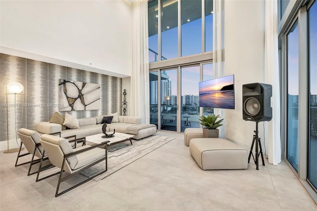 living room with a high ceiling and light tile flooring