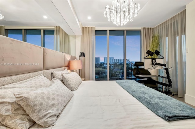 bedroom featuring access to exterior, a wall of windows, and a chandelier