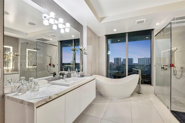 bathroom with a raised ceiling, independent shower and bath, and tile floors