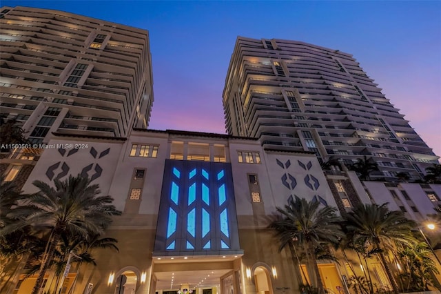 view of outdoor building at dusk