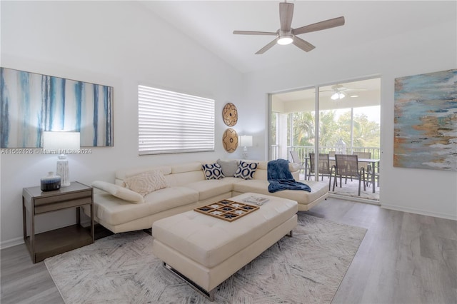 living room featuring high vaulted ceiling, ceiling fan, and light wood-type flooring