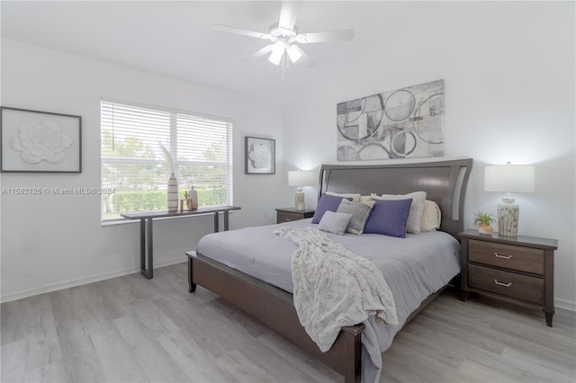 bedroom with ceiling fan and light hardwood / wood-style flooring