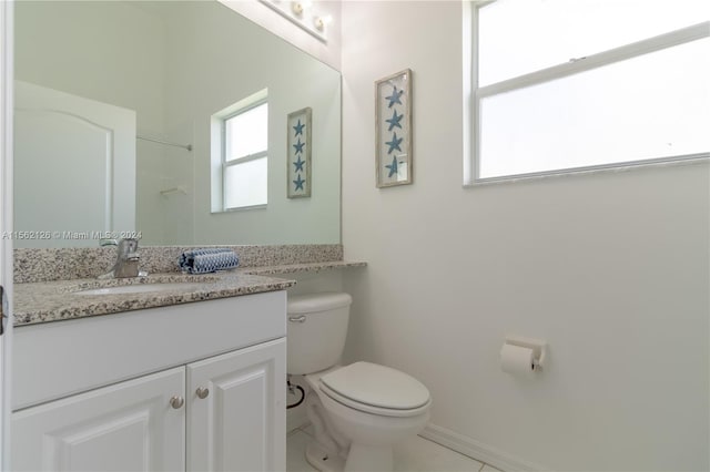 bathroom with toilet, tile floors, and oversized vanity