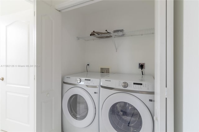 clothes washing area featuring separate washer and dryer and hookup for a washing machine