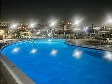 view of pool at night