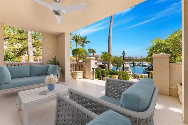 view of patio with outdoor lounge area, ceiling fan, and a water view