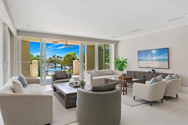 living room with expansive windows and light tile patterned floors