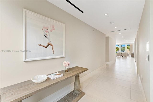 hall with light tile patterned floors