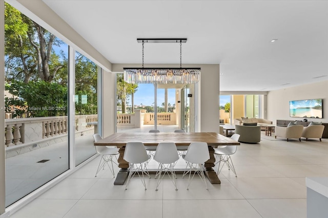 dining area with a wealth of natural light, light tile patterned floors, and a chandelier