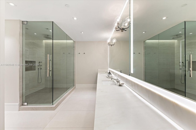 bathroom featuring tile patterned floors, a shower with door, vanity, and an inviting chandelier