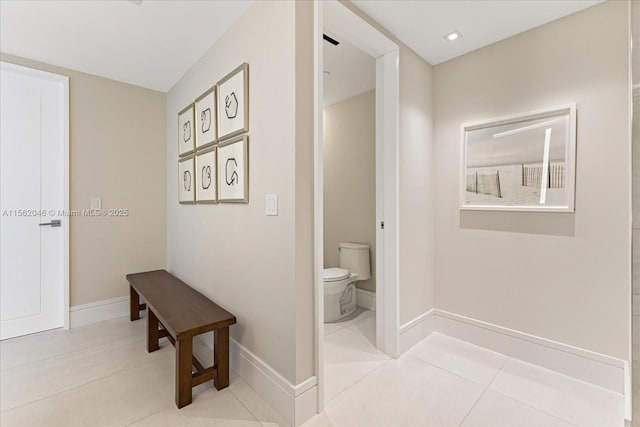 hall featuring light tile patterned flooring