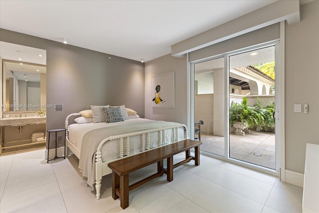 bedroom featuring access to outside, ensuite bathroom, sink, and light tile patterned floors