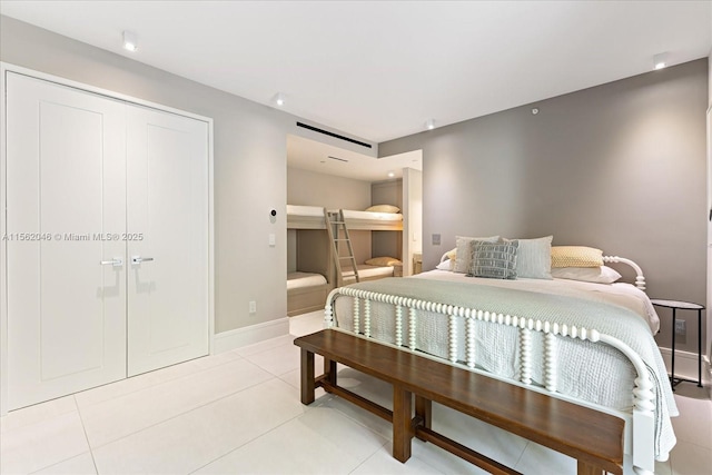 tiled bedroom with a closet