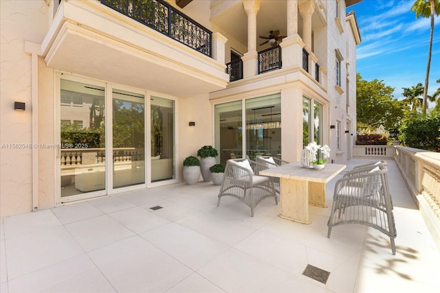 view of patio featuring ceiling fan and a balcony