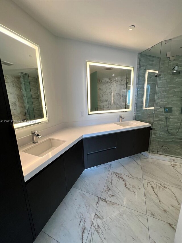 bathroom with tile flooring, a shower with shower door, and dual bowl vanity