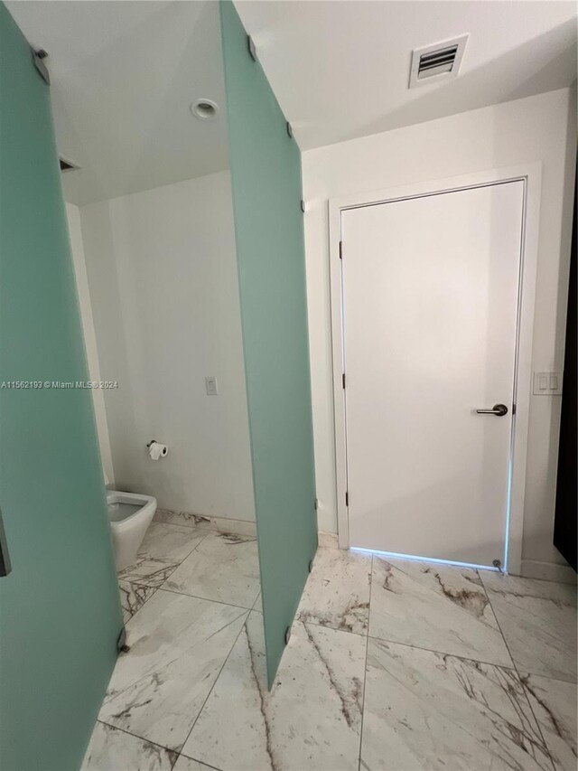 bathroom featuring toilet and tile flooring