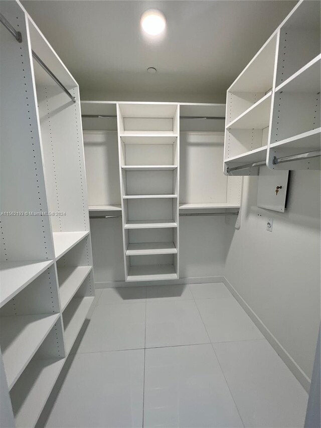 walk in closet featuring light tile floors