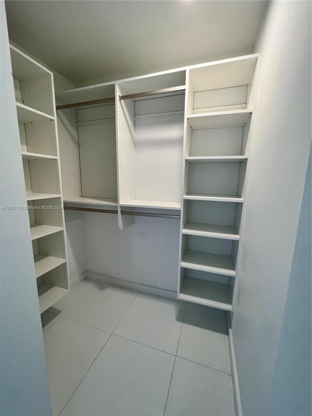 spacious closet featuring light tile floors