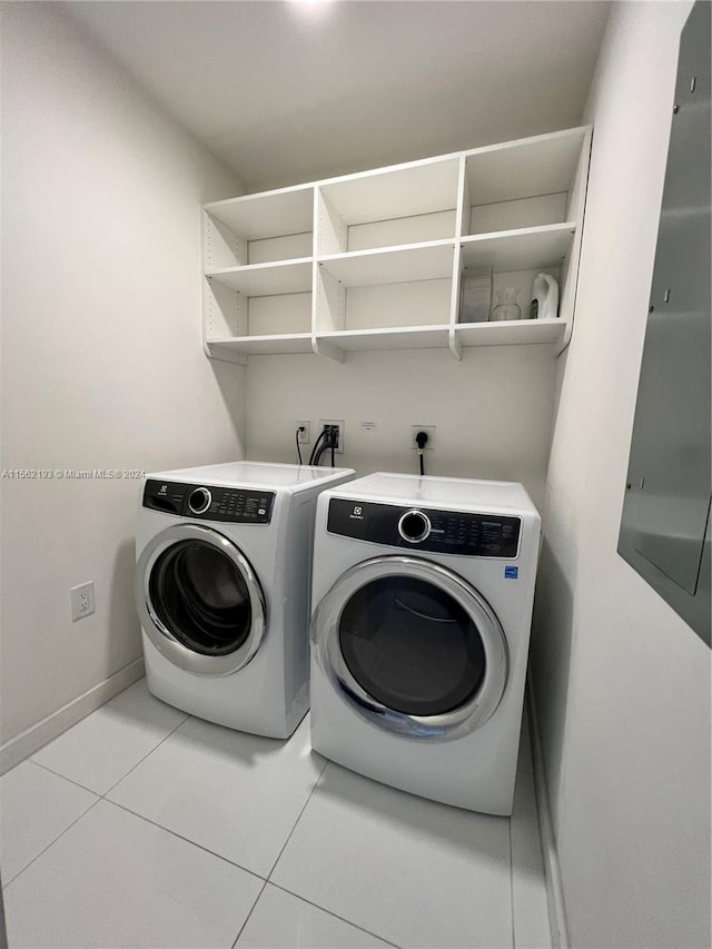 laundry area with separate washer and dryer, electric dryer hookup, light tile floors, and hookup for a washing machine