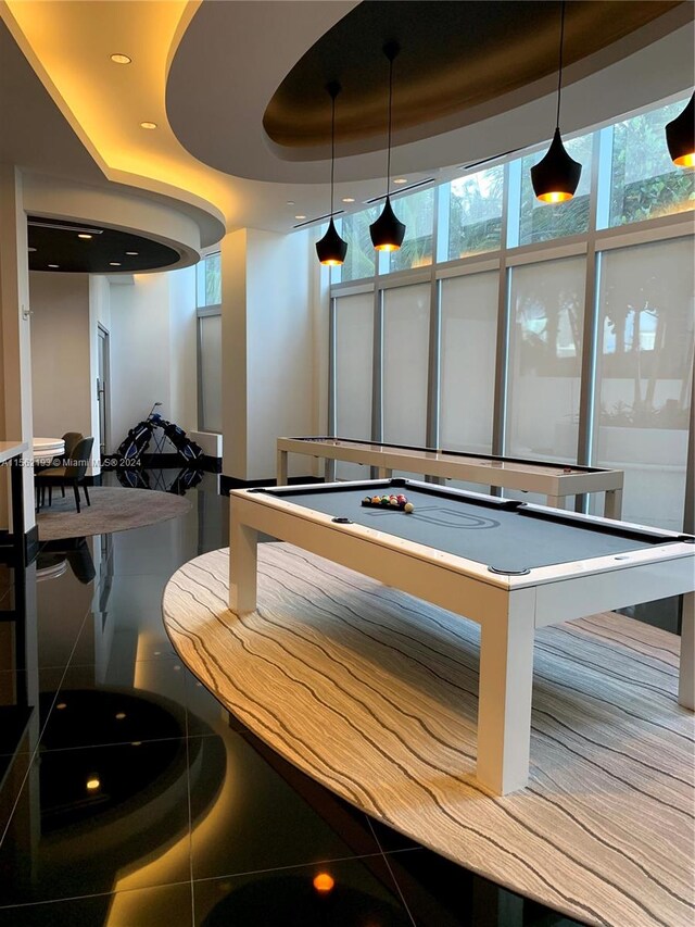 interior space featuring pool table and a raised ceiling