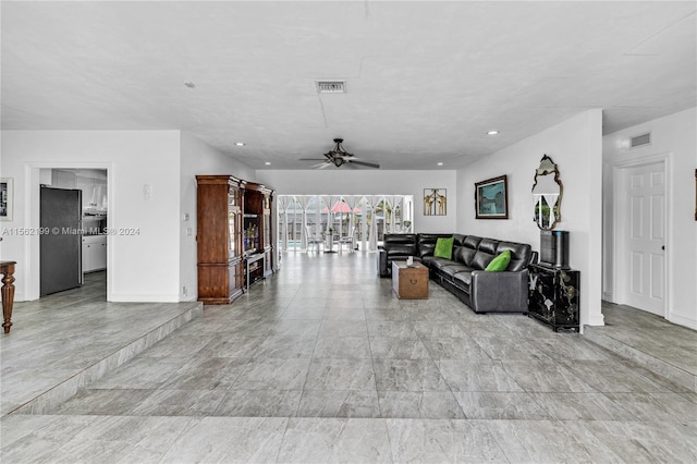 tiled living room with ceiling fan