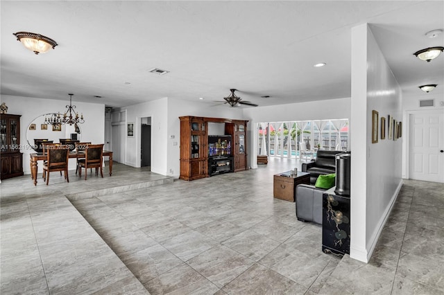 living room featuring ceiling fan with notable chandelier and light tile floors