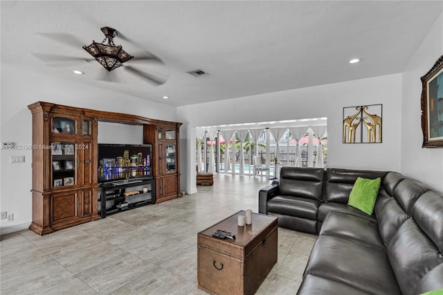 living room with light tile flooring and ceiling fan