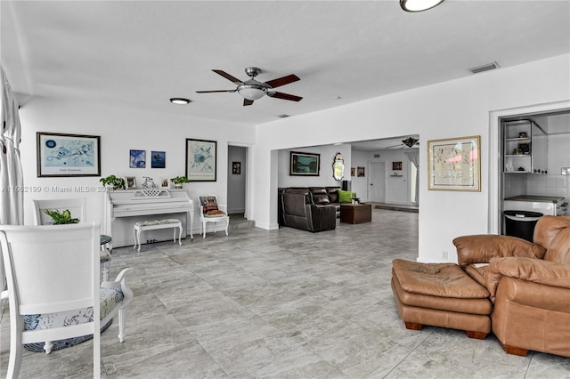 living room featuring ceiling fan and light tile floors