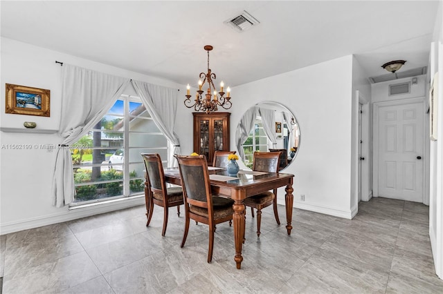 tiled dining area with a notable chandelier