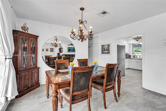 tiled dining space featuring a notable chandelier and sink