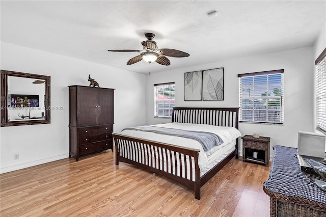 bedroom featuring multiple windows, light wood-type flooring, and ceiling fan