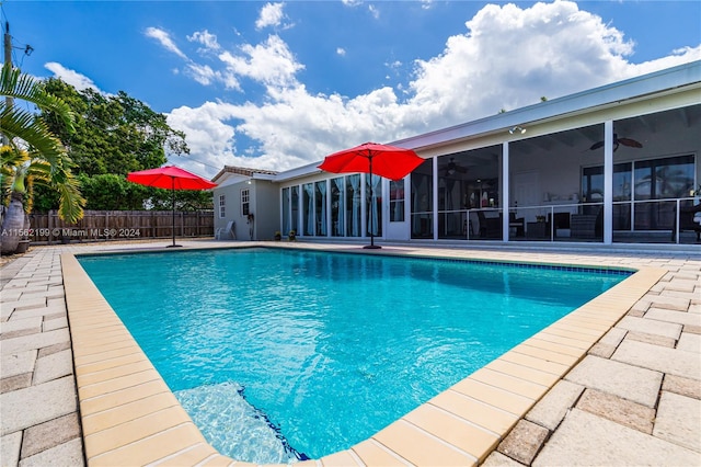 view of swimming pool with a patio and ceiling fan