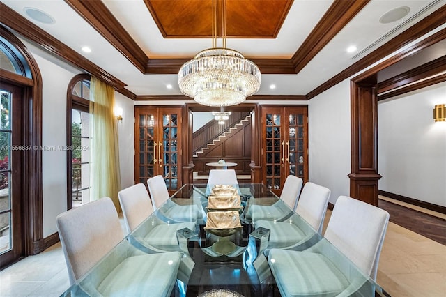 dining area featuring ornamental molding, a notable chandelier, and a tray ceiling