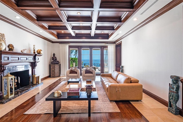 living room with french doors, coffered ceiling, a fireplace, and ornamental molding