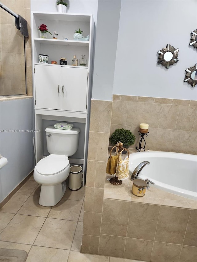 bathroom with tiled bath, toilet, and tile flooring