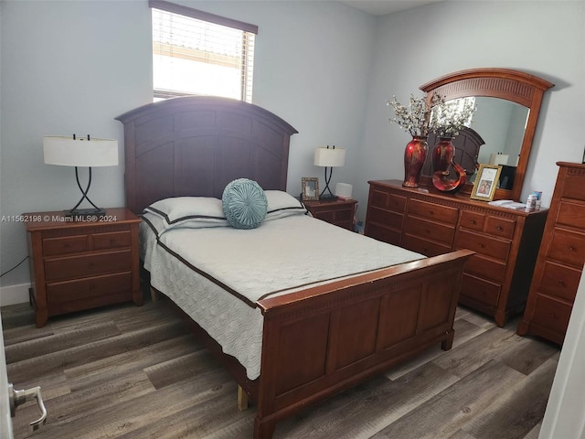 bedroom with dark hardwood / wood-style floors