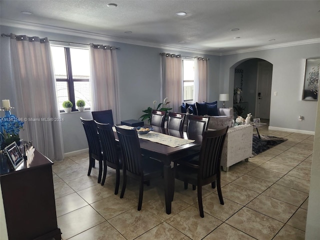 dining room featuring light tile flooring and ornamental molding