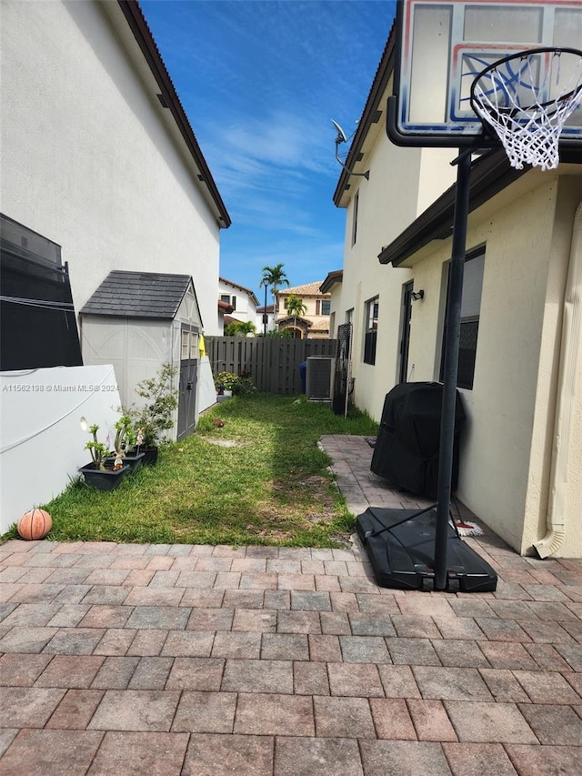 view of patio with a storage unit