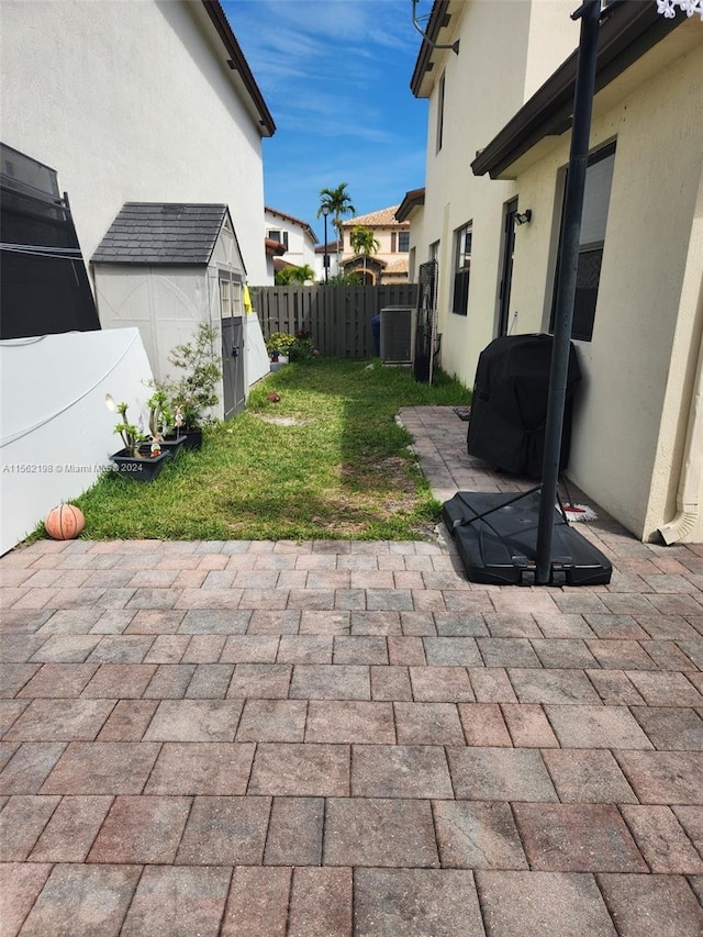 view of patio / terrace featuring a storage unit and central AC unit