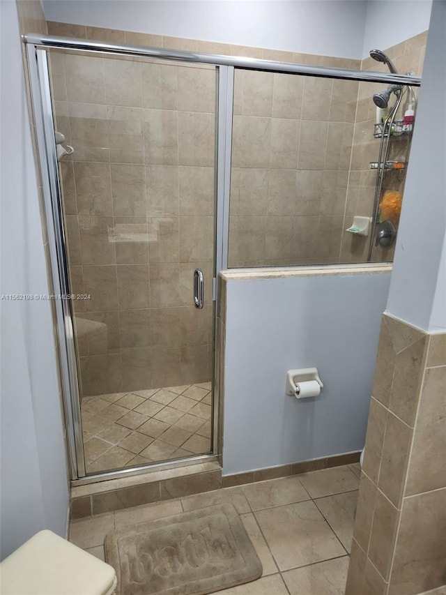 bathroom featuring tile floors and an enclosed shower